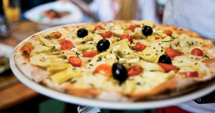 A home-made pizza at Mamma Mia topped with artichokes, cherry tomatoes and olives